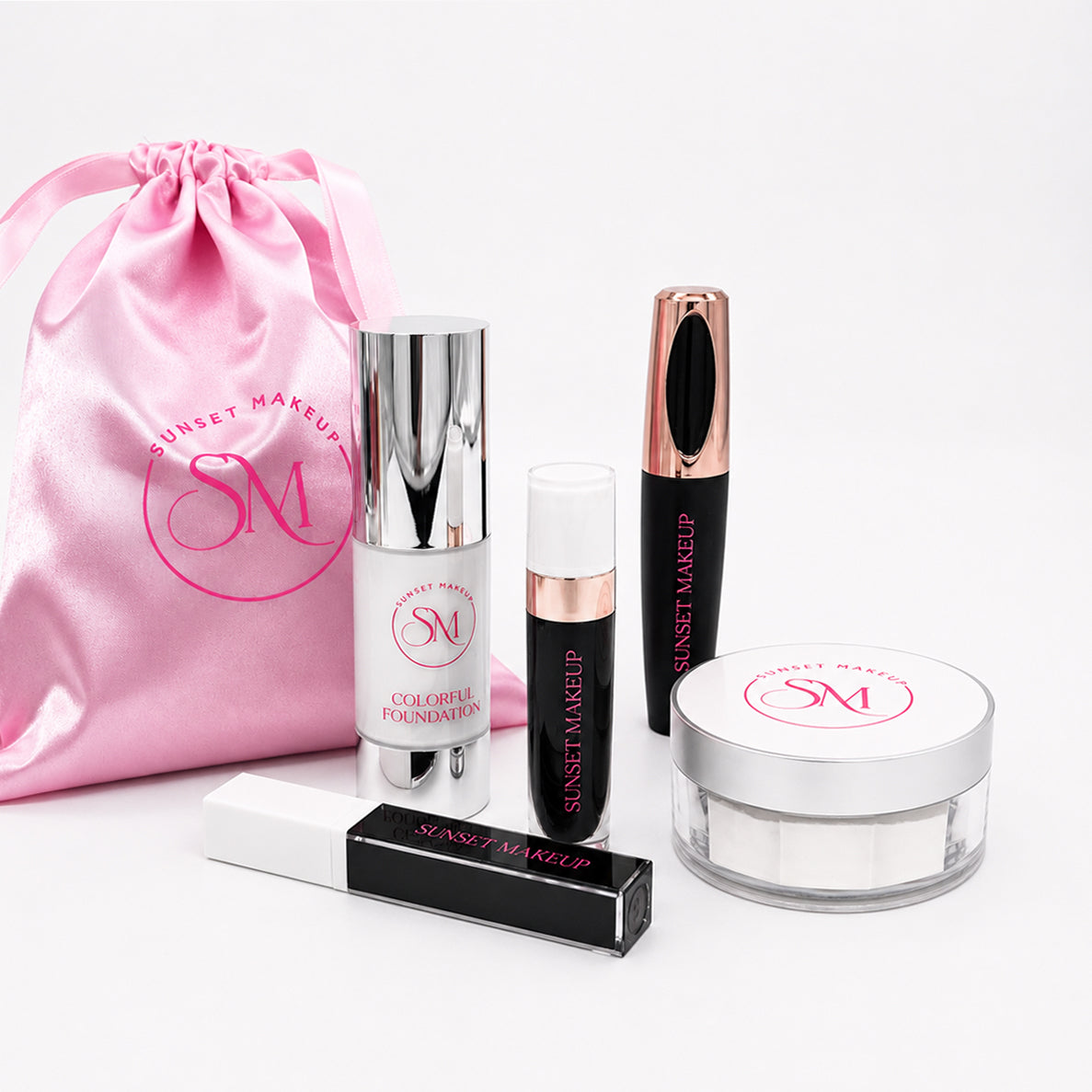 Sunset Makeup cosmetic set on a white background, including a pink satin drawstring bag, White Colorful Foundation, Black Matte Liquid Lipstick #39 “Existence", White Colorful Mascara #10, Six Feet Below Black Lip Gloss, and Setting Powder #9 White.