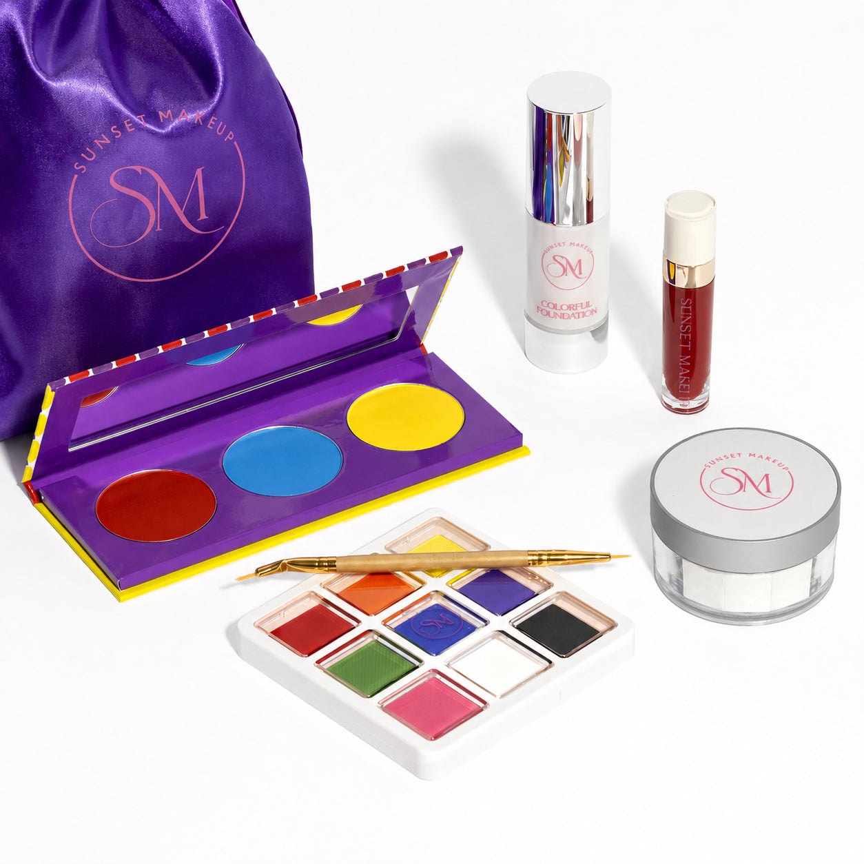 Sunset Makeup Clown Makeup Bundle for cosplay with white foundation, translucent setting powder, colorful water-activated eyeliner and face paint palette, red matte liquid lipstick, brush, and purple makeup bag.